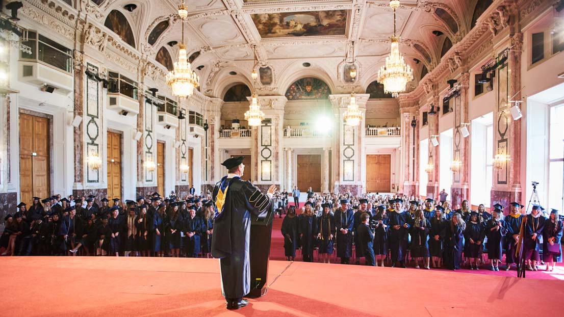 view from the stage at audience of graduates, Webster University in Vienna commencement 2022
