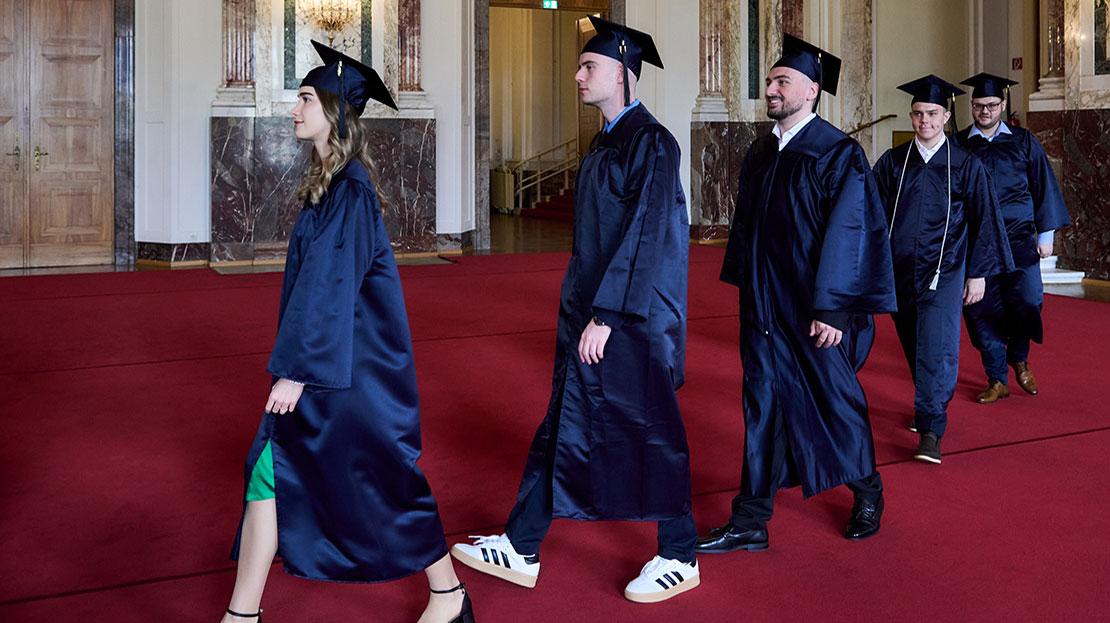 Students at Webster University in Vienna commencement 2025 walking into auditorium